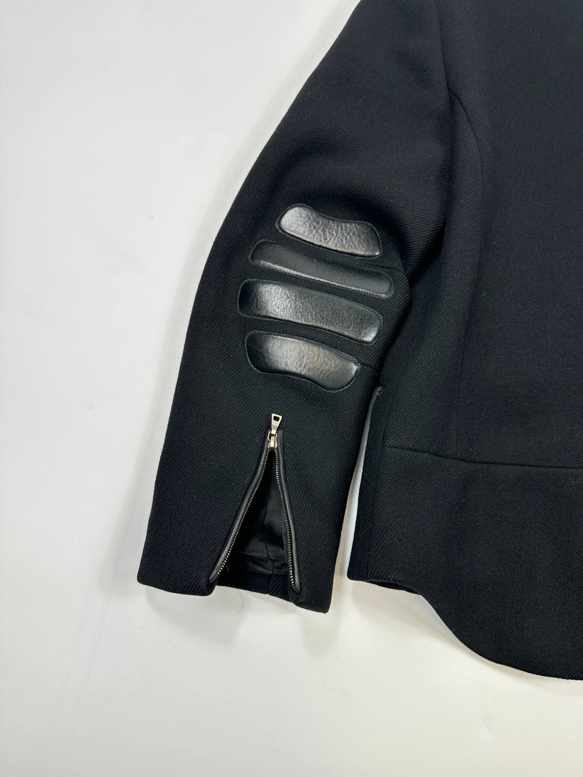Prada black wool and leather jacket with biker-style detailing and logo accents.