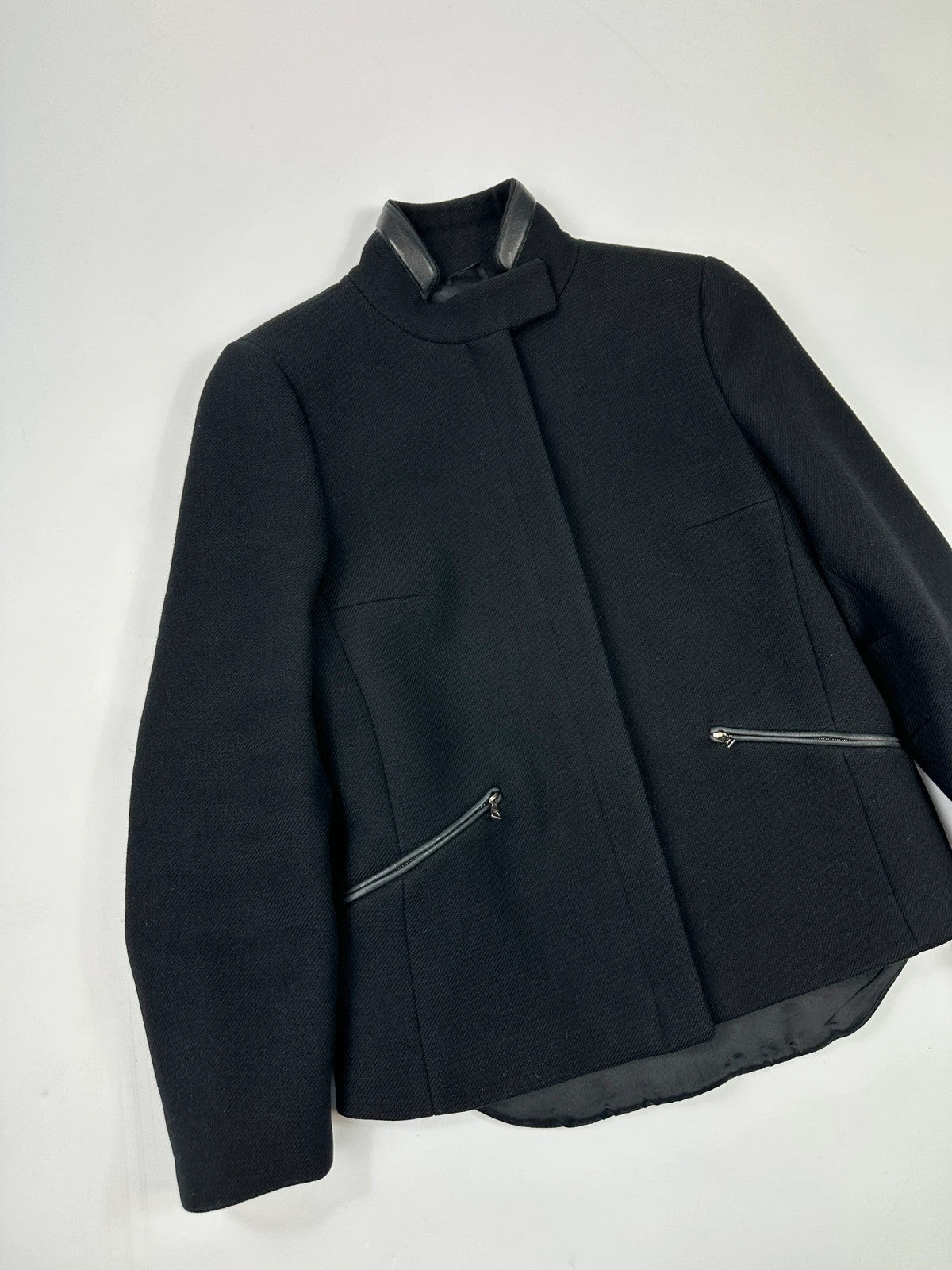 Prada black wool and leather jacket with biker-style detailing and logo accents.