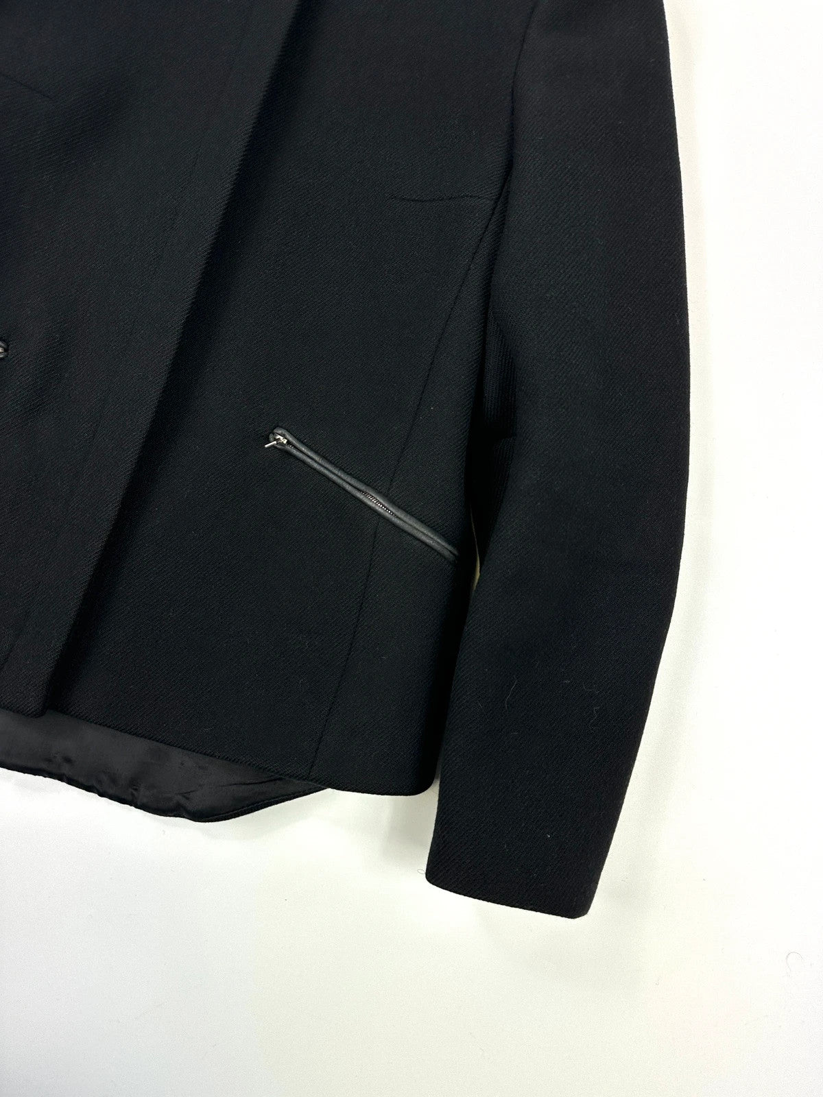 Prada black wool and leather jacket with biker-style detailing and logo accents.
