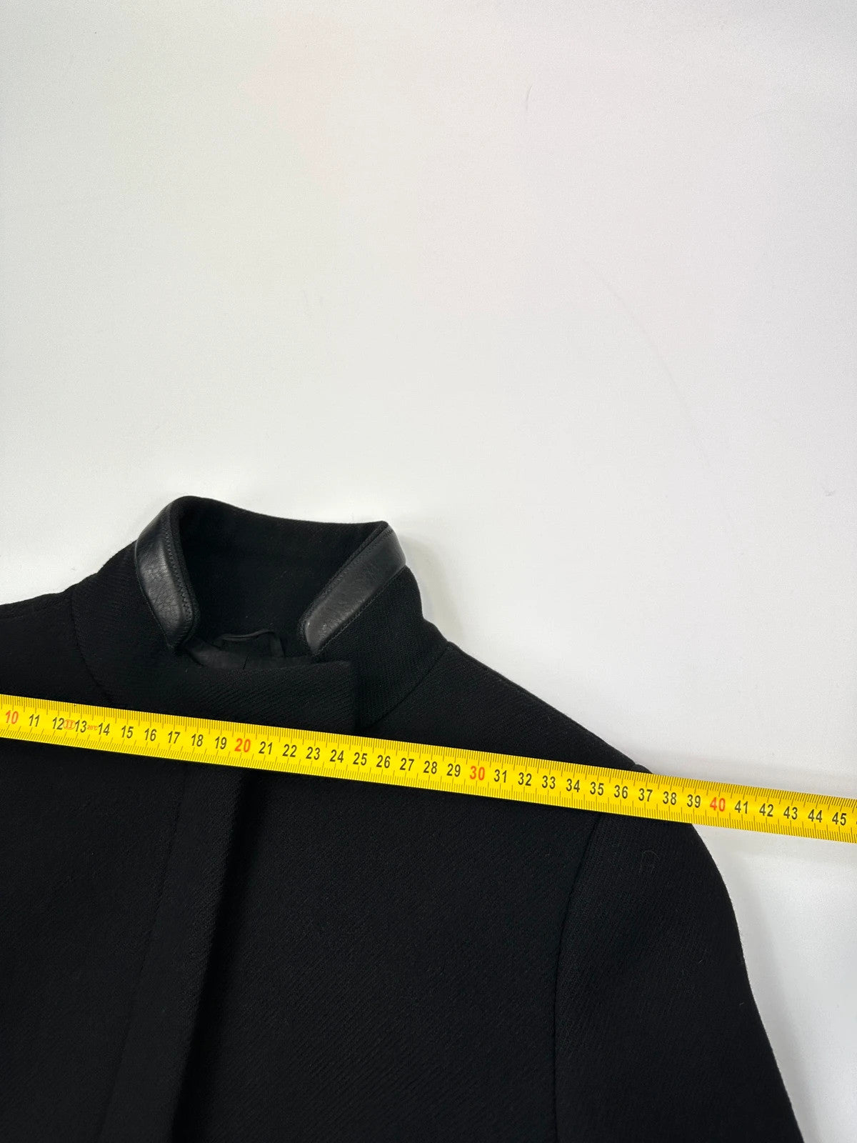 Prada black wool and leather jacket with biker-style detailing and logo accents.
