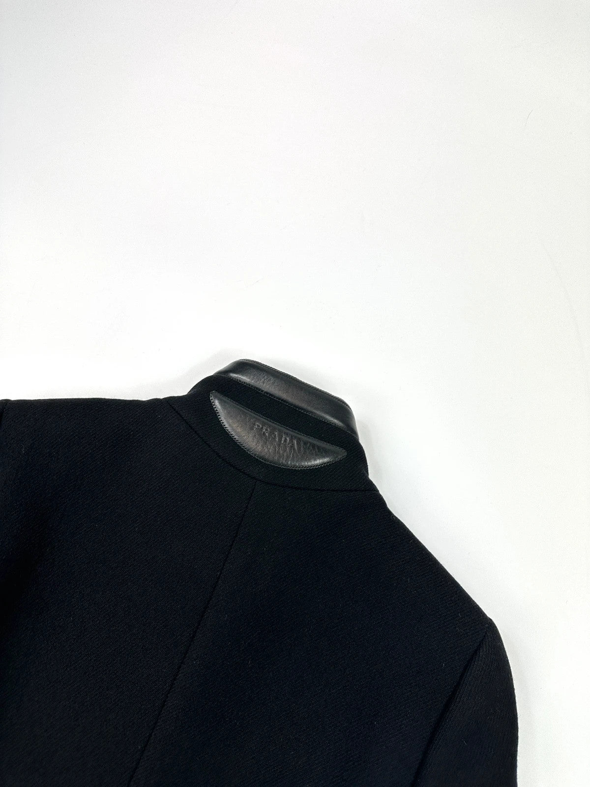 Prada black wool and leather jacket with biker-style detailing and logo accents.