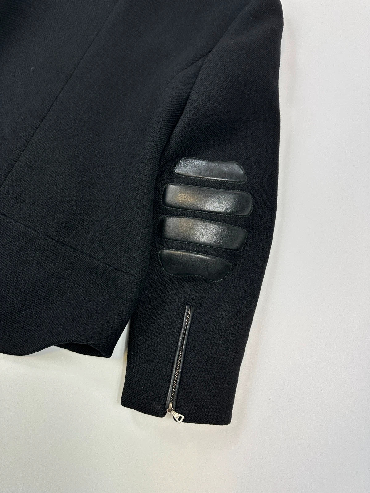 Prada black wool and leather jacket with biker-style detailing and logo accents.