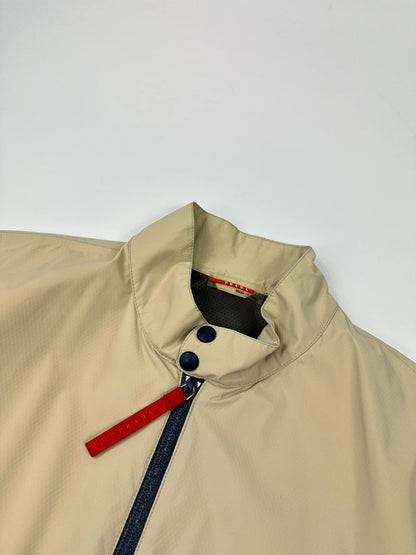 Prada beige Gore-Tex jacket packable into pocket, features logo and nylon material.