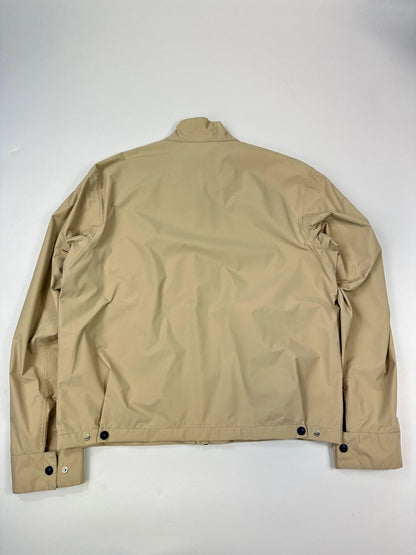 Prada beige Gore-Tex jacket packable into pocket, features logo and nylon material.