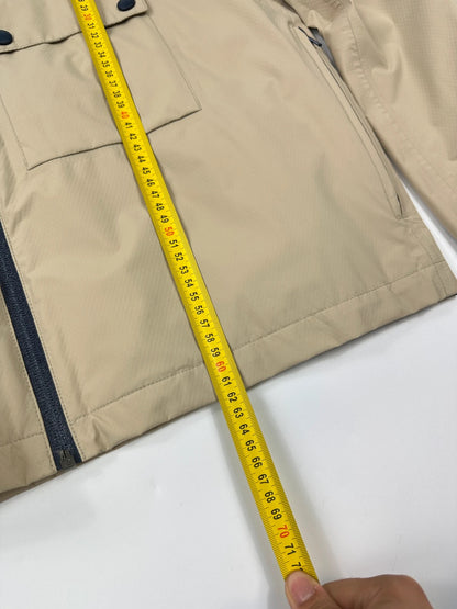 Prada beige Gore-Tex jacket packable into pocket, features logo and nylon material.