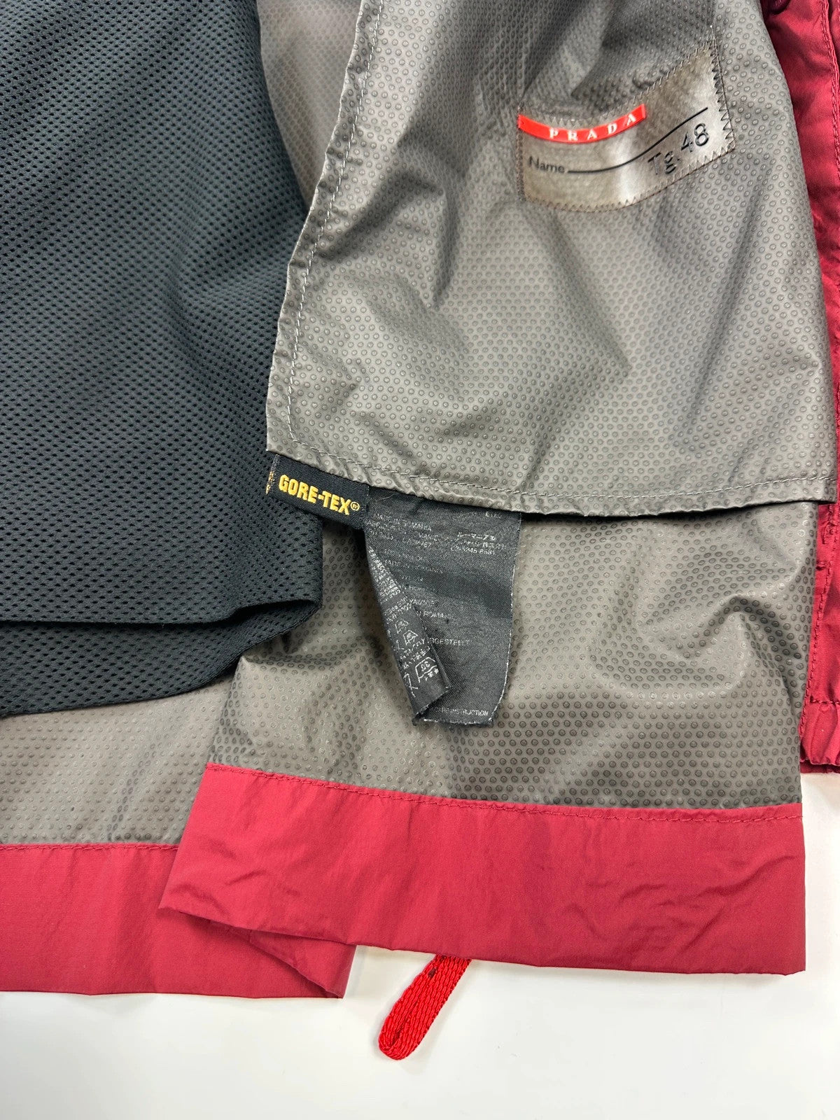 Prada red Gore-Tex jacket with logo detail, vintage Autumn-Winter 2003 collection.