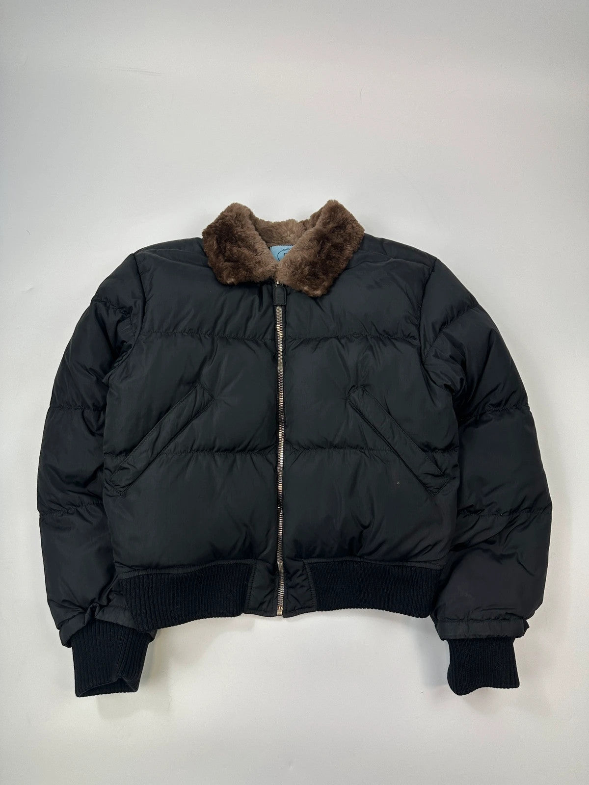 Prada black cropped bomber puffer jacket with logo detailing and vintage 90s design.