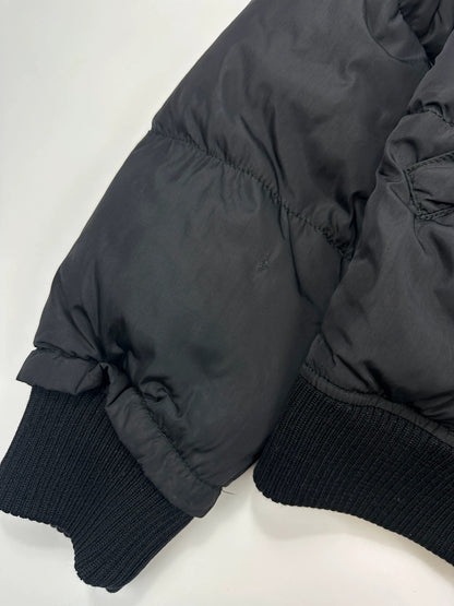 Prada black cropped bomber puffer jacket with logo detailing and vintage 90s design.