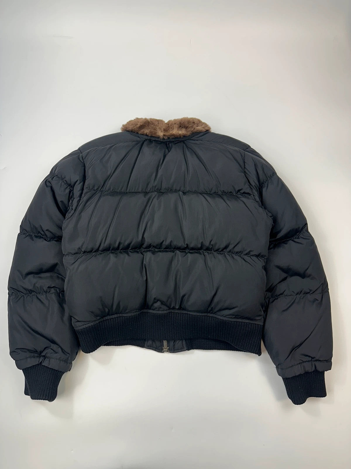 Prada black cropped bomber puffer jacket with logo detailing and vintage 90s design.