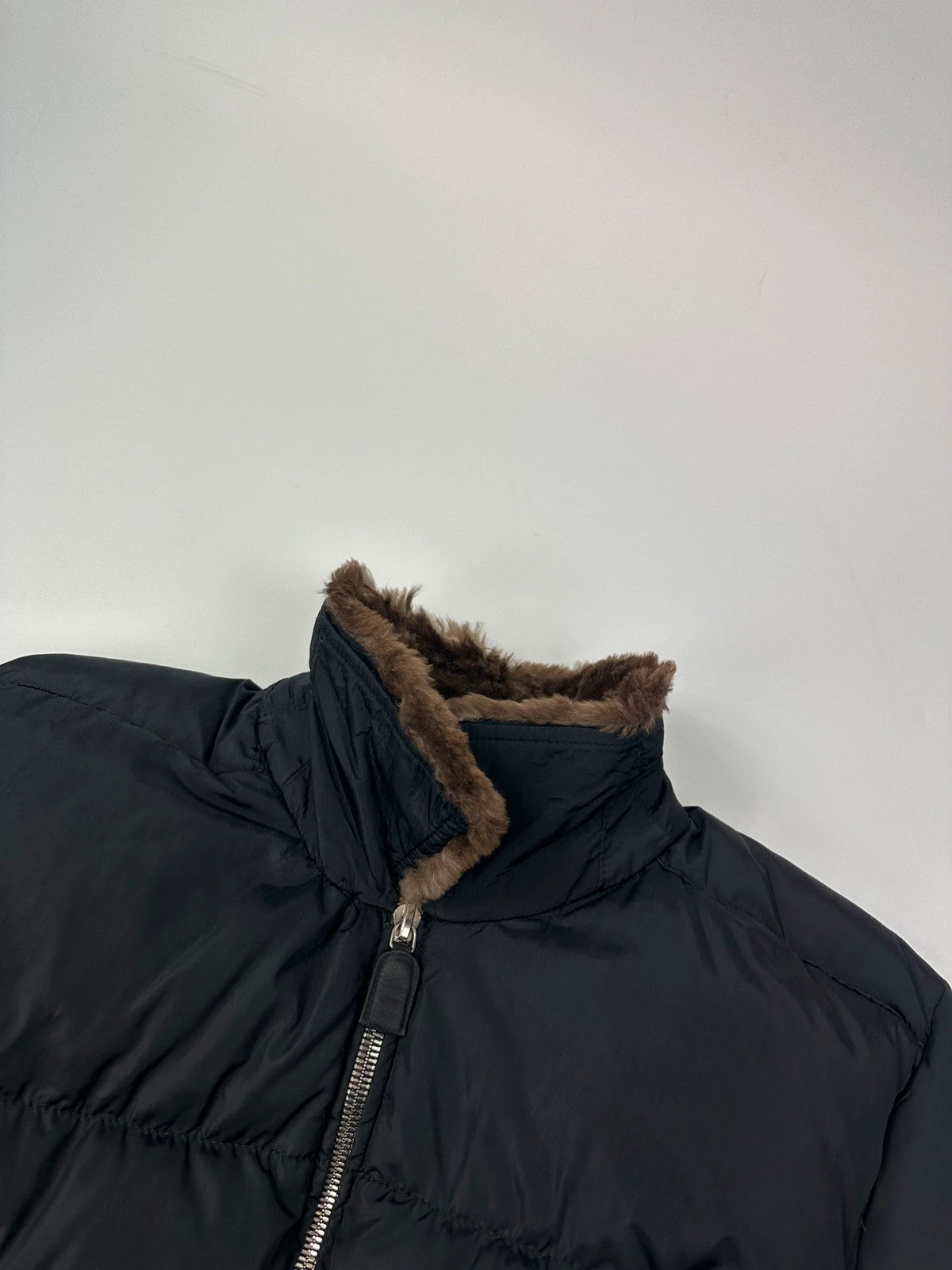 Prada black cropped bomber puffer jacket with logo detailing and vintage 90s design.