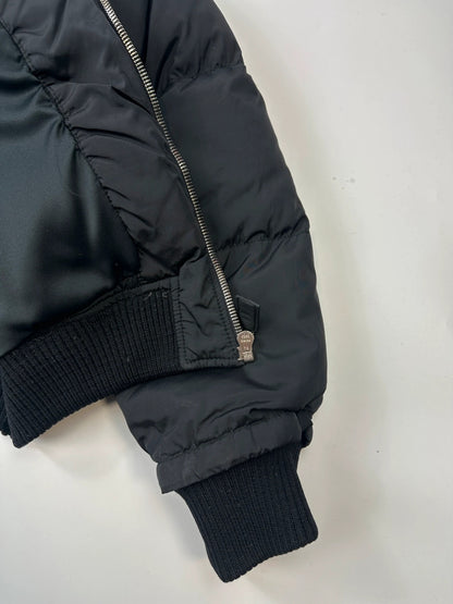 Prada black cropped bomber puffer jacket with logo detailing and vintage 90s design.