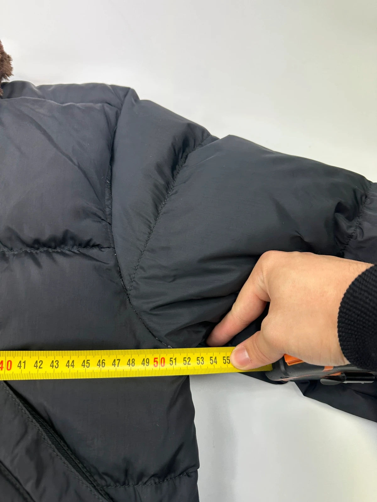 Prada black cropped bomber puffer jacket with logo detailing and vintage 90s design.