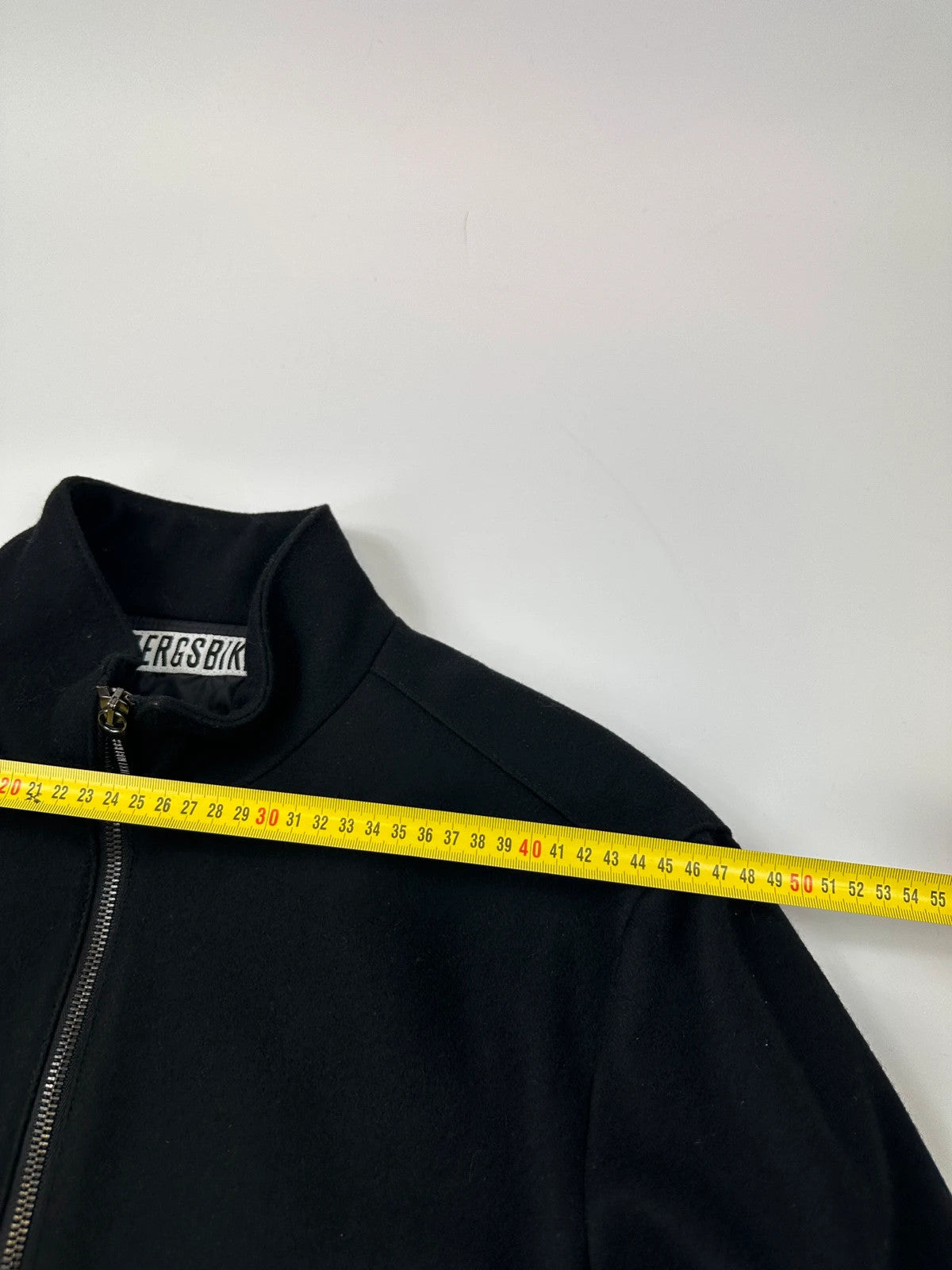 Bikkembergs black wool and leather jacket with minimalist design and subtle logo details.