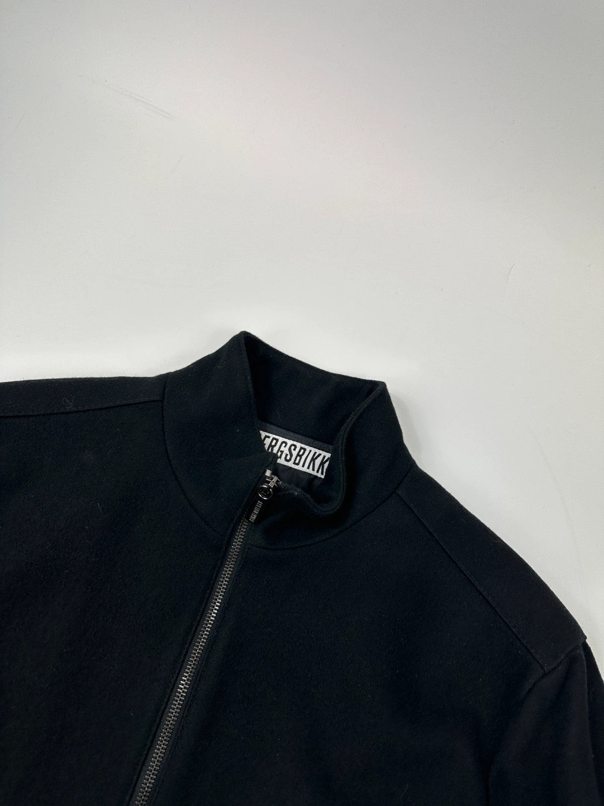 Bikkembergs black wool and leather jacket with minimalist design and subtle logo details.