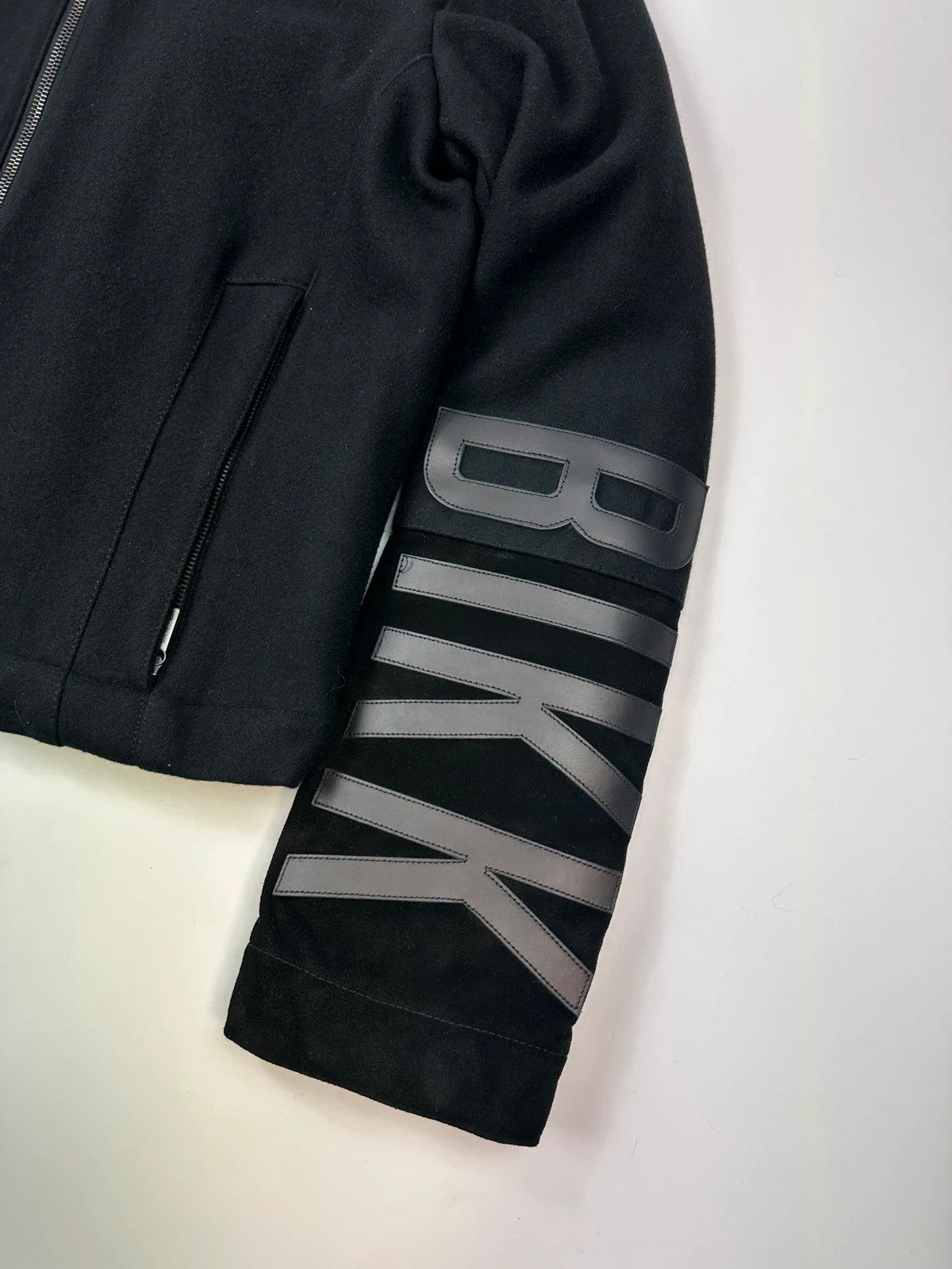 Bikkembergs black wool and leather jacket with minimalist design and subtle logo details.