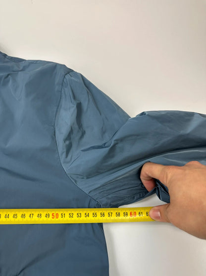 Prada blue reversible bomber jacket, nylon material, featuring logo and sleek minimalist design.