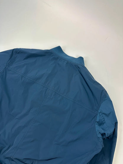 Prada blue reversible bomber jacket, nylon material, featuring logo and sleek minimalist design.