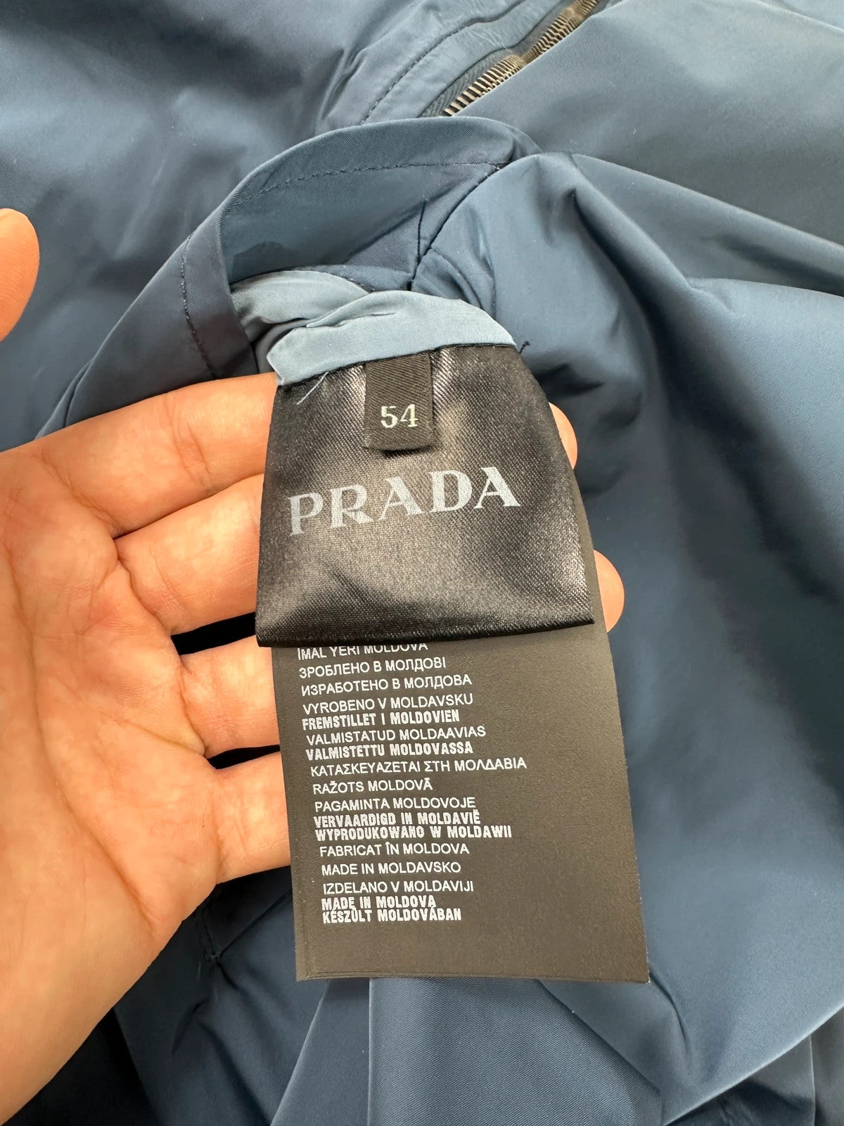 Prada blue reversible bomber jacket, nylon material, featuring logo and sleek minimalist design.