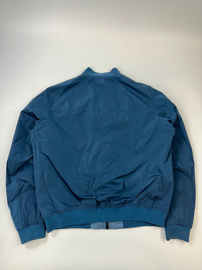 Prada blue reversible bomber jacket, nylon material, featuring logo and sleek minimalist design.