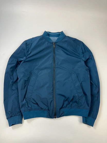 Prada blue reversible bomber jacket, nylon material, featuring logo and sleek minimalist design.