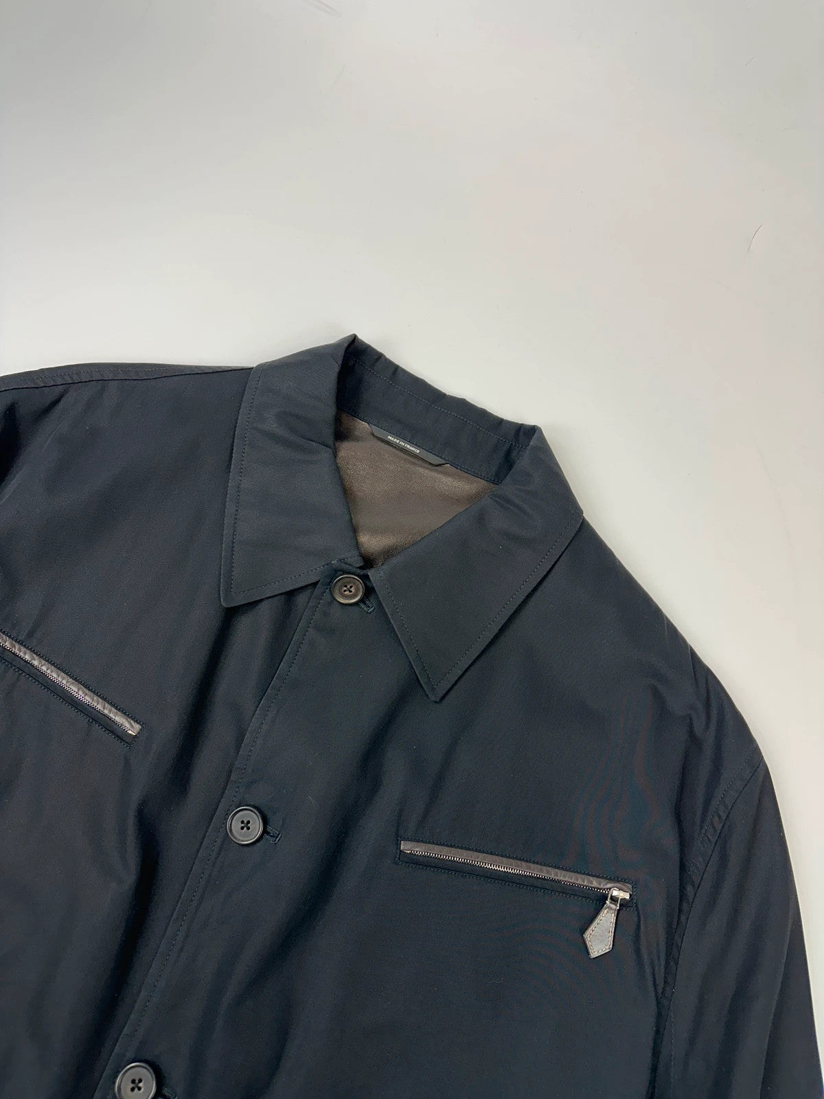 Hermès brown and navy jacket with leather straps and buttons, vintage 2000s design.