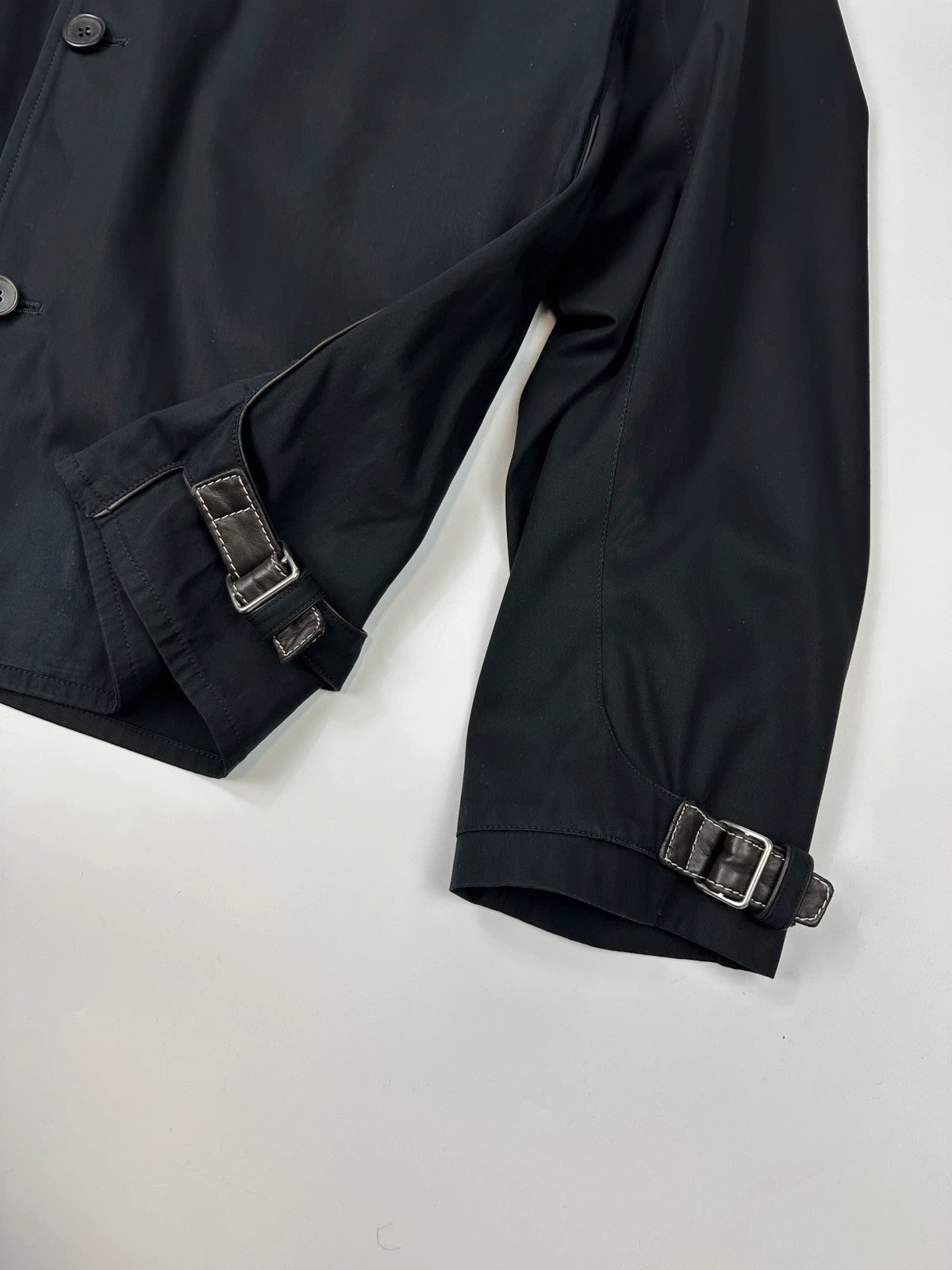 Hermès brown and navy jacket with leather straps and buttons, vintage 2000s design.