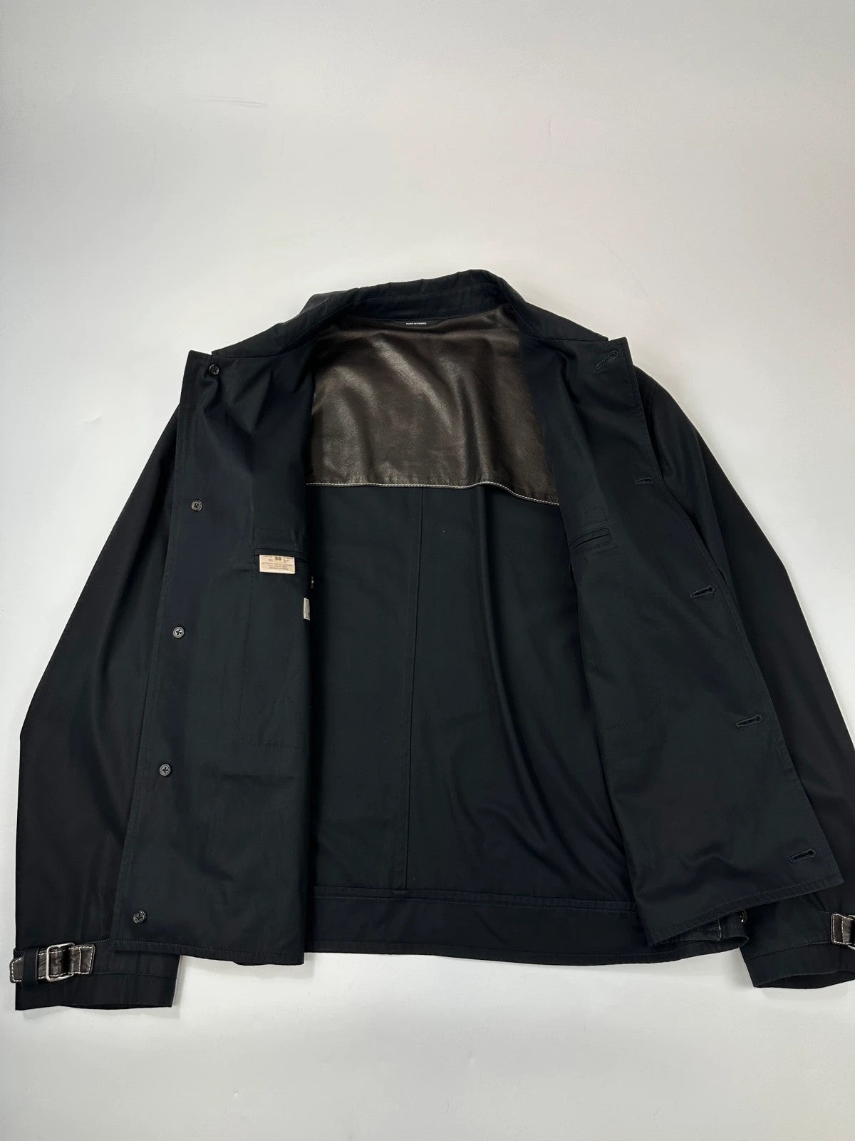 Hermès brown and navy jacket with leather straps and buttons, vintage 2000s design.
