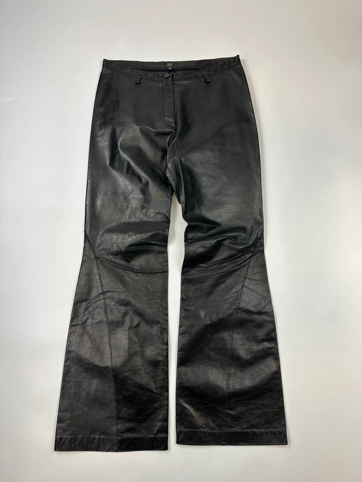Marithé François Girbaud black flared leather-look trousers with soft texture and vintage design.