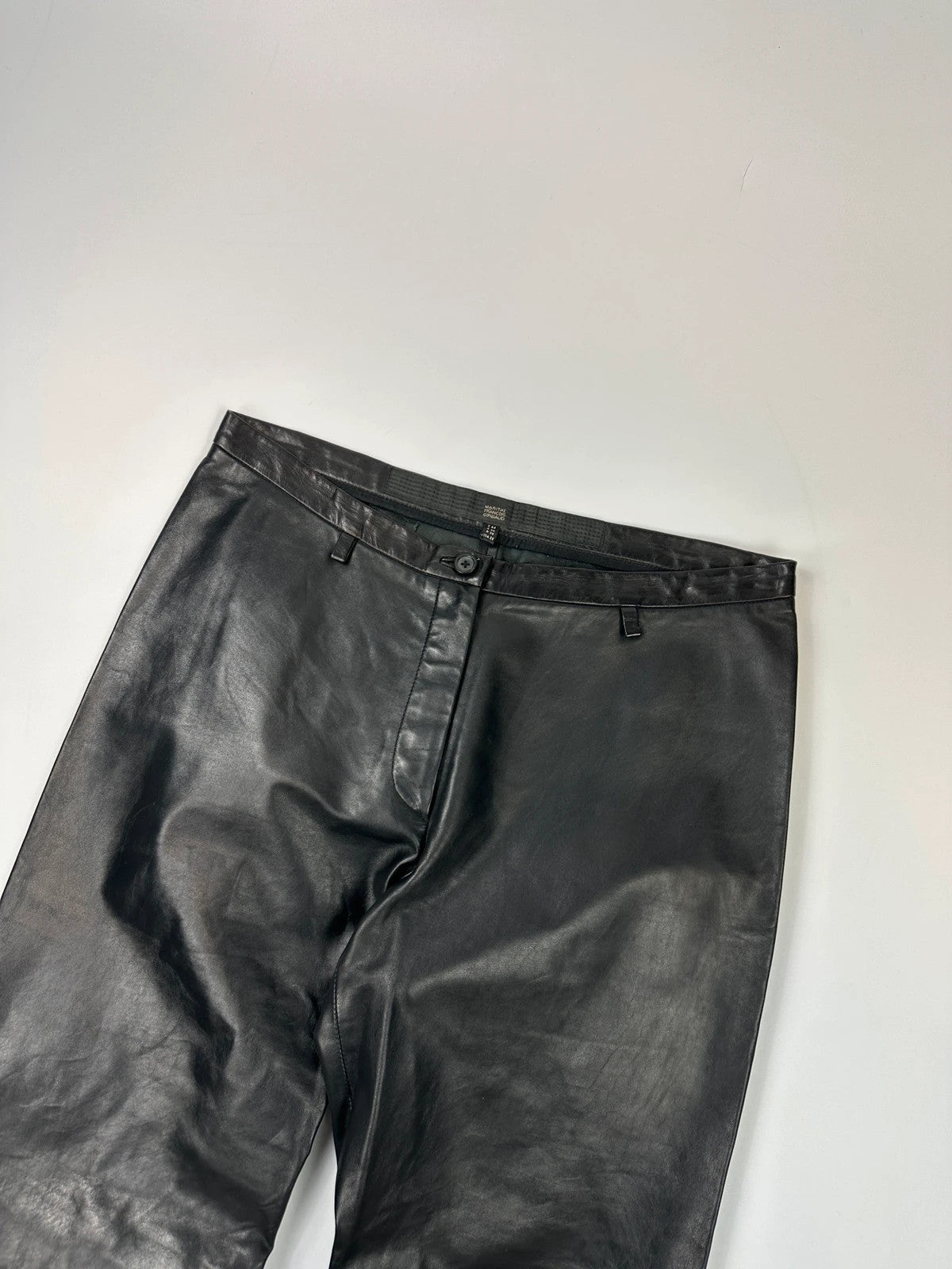 Marithé François Girbaud black flared leather-look trousers with soft texture and vintage design.