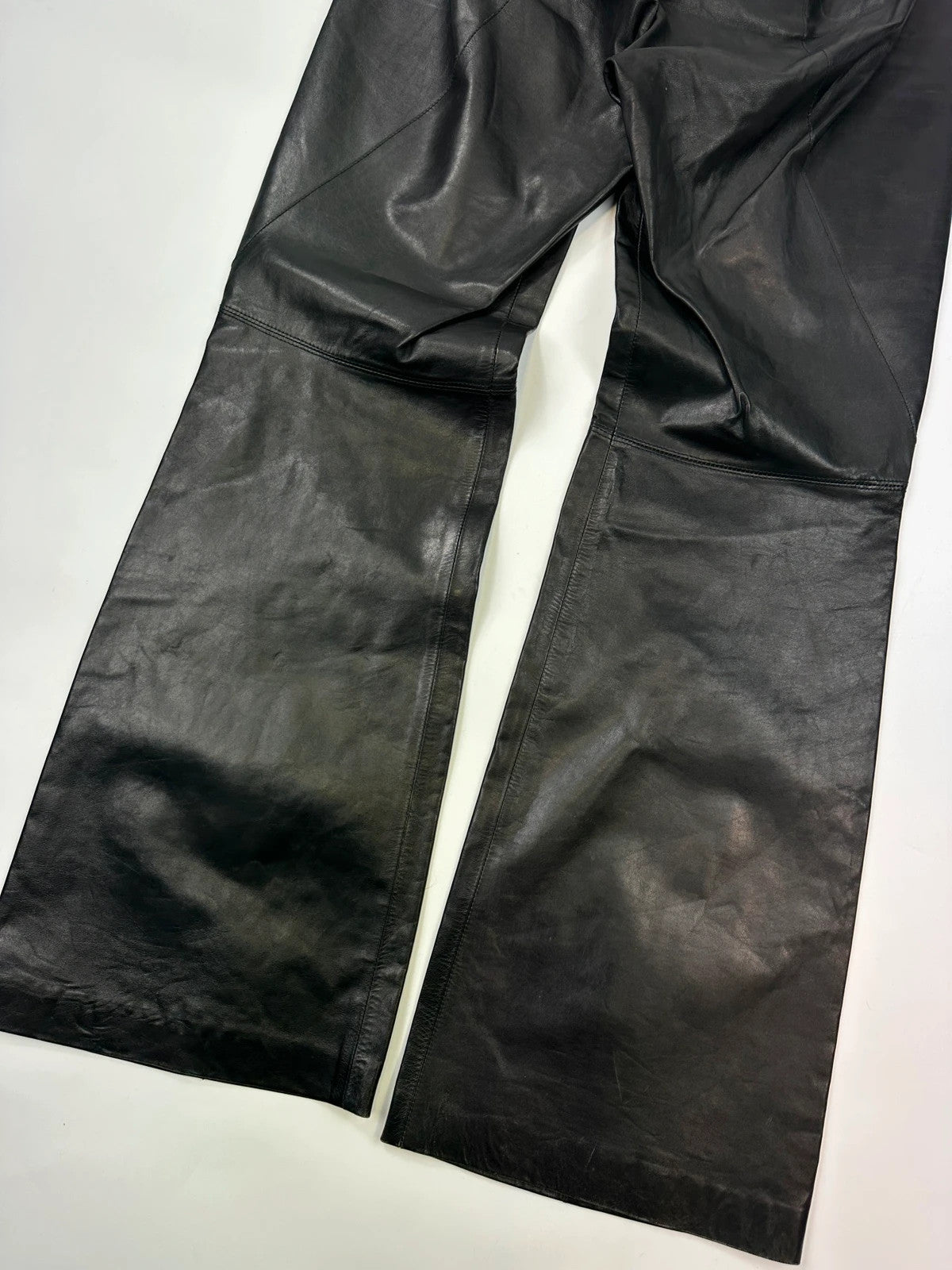 Marithé François Girbaud black flared leather-look trousers with soft texture and vintage design.