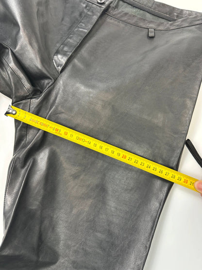 Marithé François Girbaud black flared leather-look trousers with soft texture and vintage design.