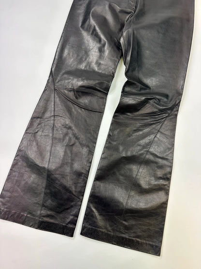 Marithé François Girbaud black flared leather-look trousers with soft texture and vintage design.