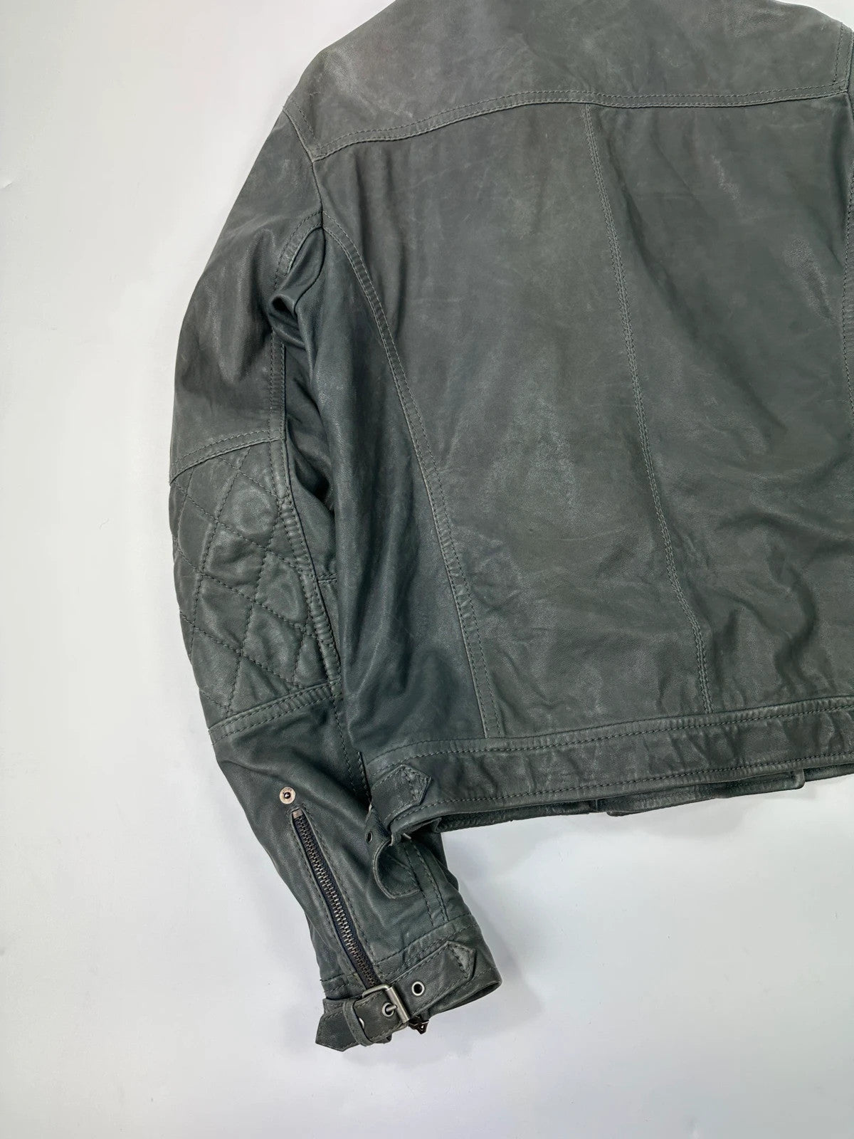 John Galliano khaki green leather jacket with side zip and soft texture.