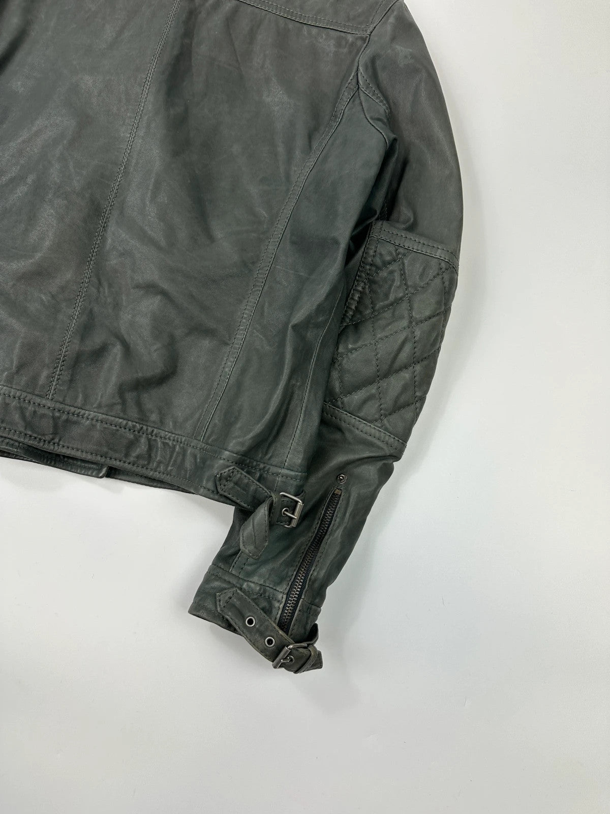 John Galliano khaki green leather jacket with side zip and soft texture.