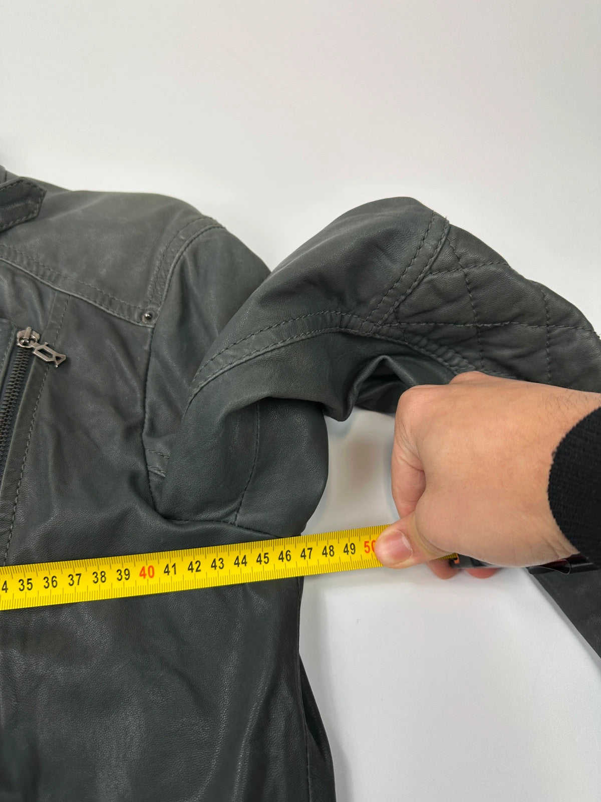 John Galliano khaki green leather jacket with side zip and soft texture.