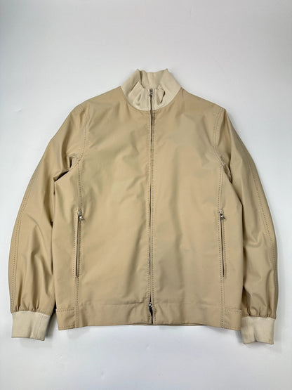 Prada beige Gore-Tex nylon jacket with logo detail and minimalist design.