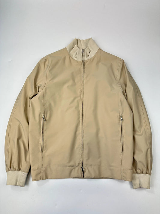 Prada beige Gore-Tex nylon jacket with logo detail and minimalist design.