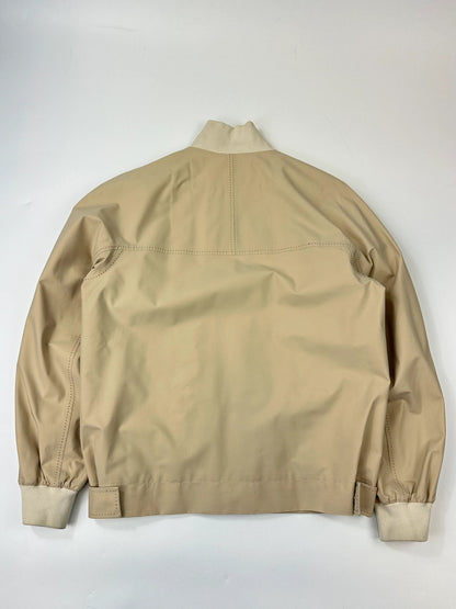 Prada beige Gore-Tex nylon jacket with logo detail and minimalist design.