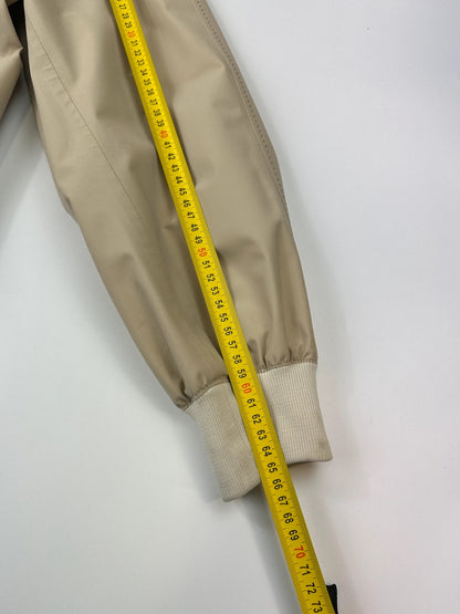 Prada beige Gore-Tex nylon jacket with logo detail and minimalist design.
