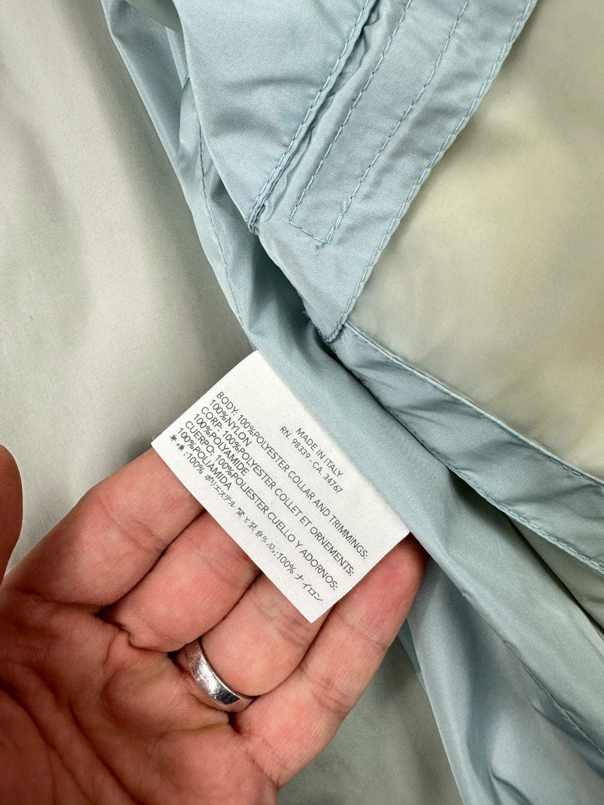 Prada beige Gore-Tex nylon jacket with logo detail and minimalist design.