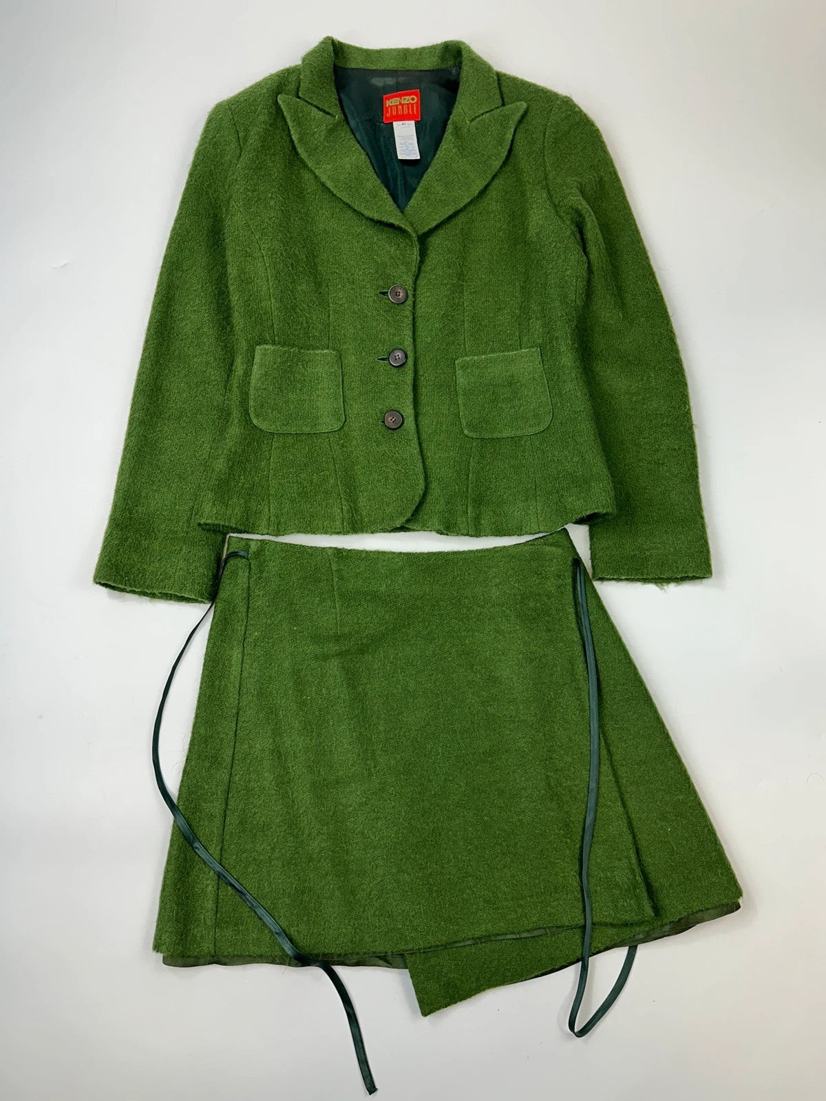 Kenzo green mohair skirt suit set with adjustable wrap skirt and logo detail.