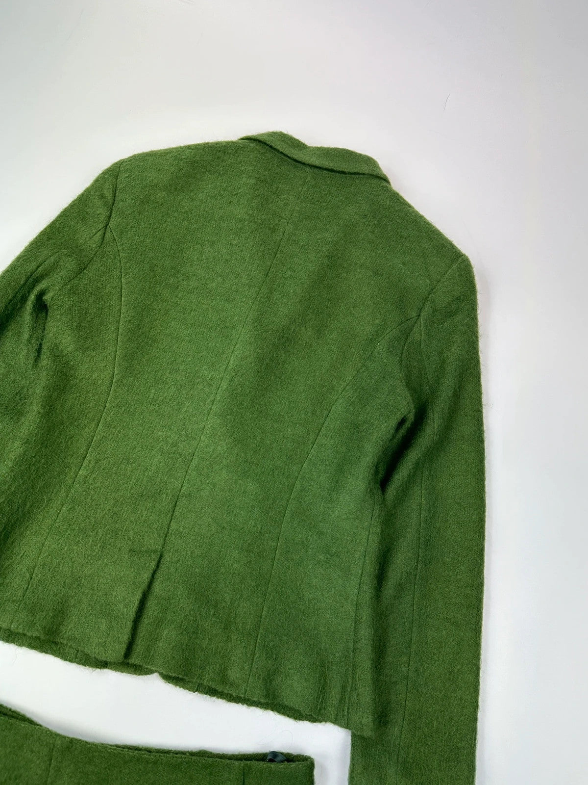 Kenzo green mohair skirt suit set with adjustable wrap skirt and logo detail.