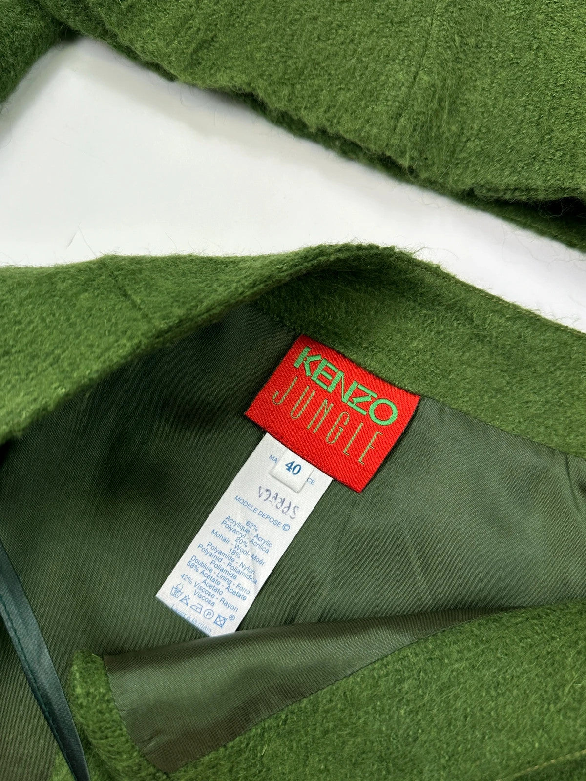 Kenzo green mohair skirt suit set with adjustable wrap skirt and logo detail.
