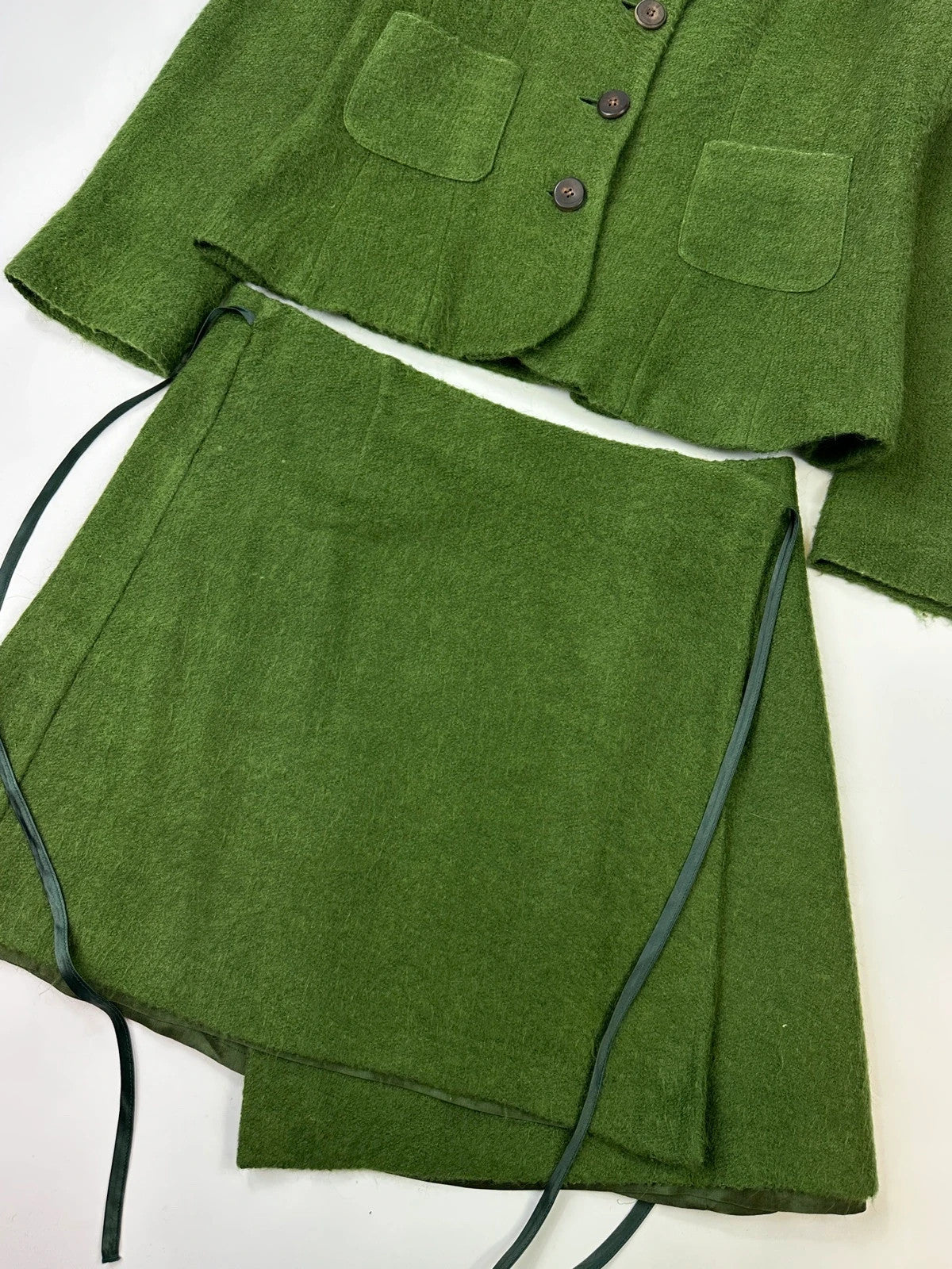 Kenzo green mohair skirt suit set with adjustable wrap skirt and logo detail.