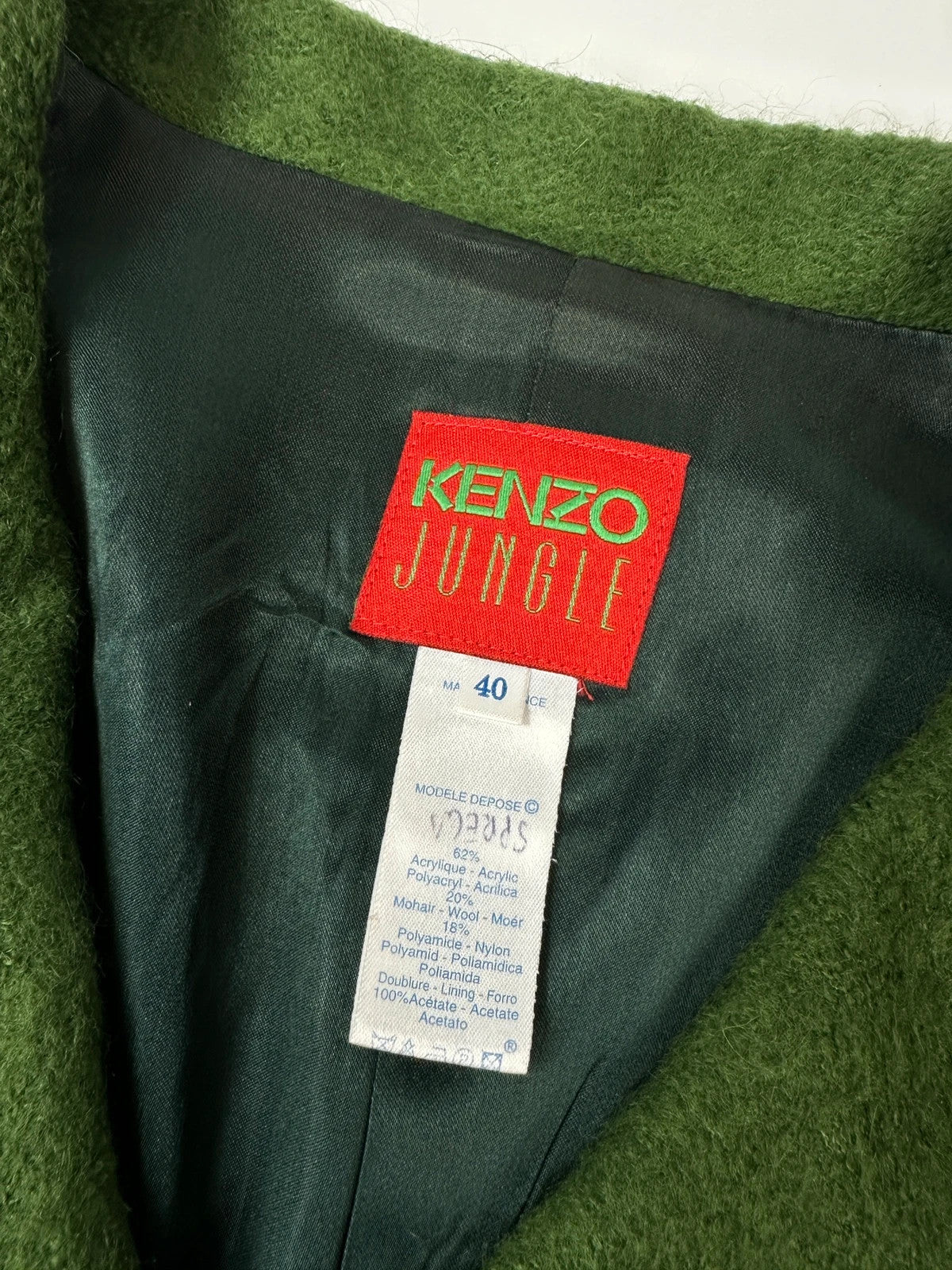 Kenzo green mohair skirt suit set with adjustable wrap skirt and logo detail.