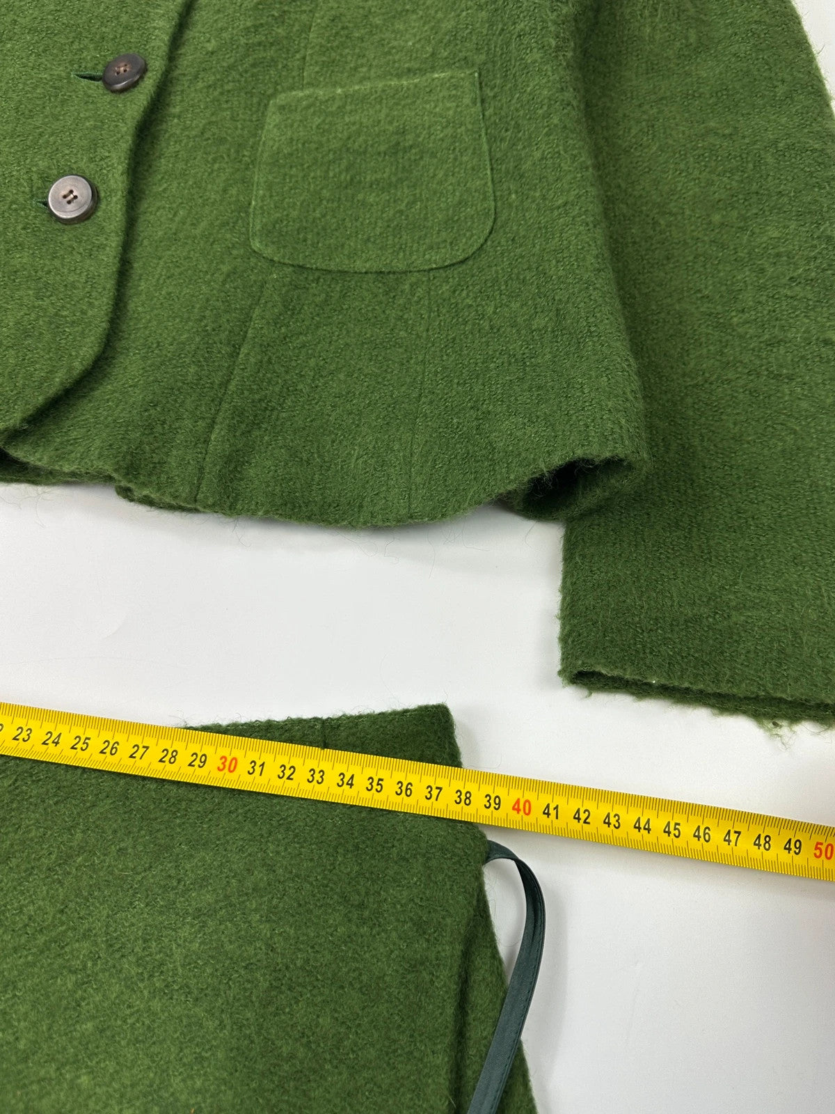 Kenzo green mohair skirt suit set with adjustable wrap skirt and logo detail.