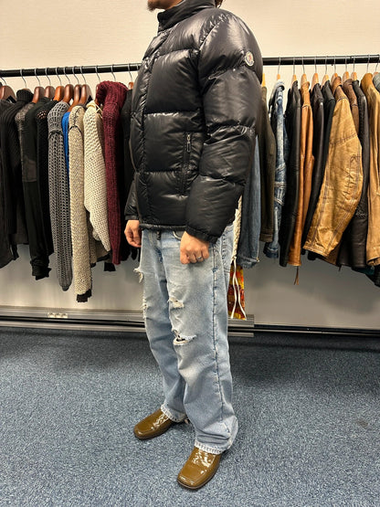Moncler black nylon hooded puffer jacket with vintage logo and down filling.