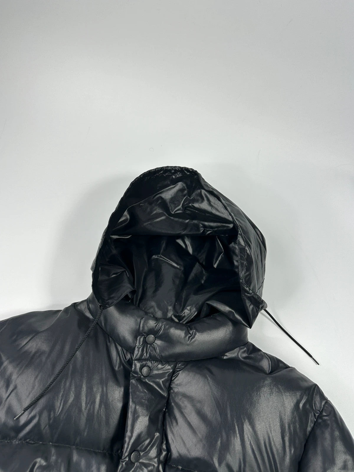 Moncler black nylon hooded puffer jacket with vintage logo and down filling.