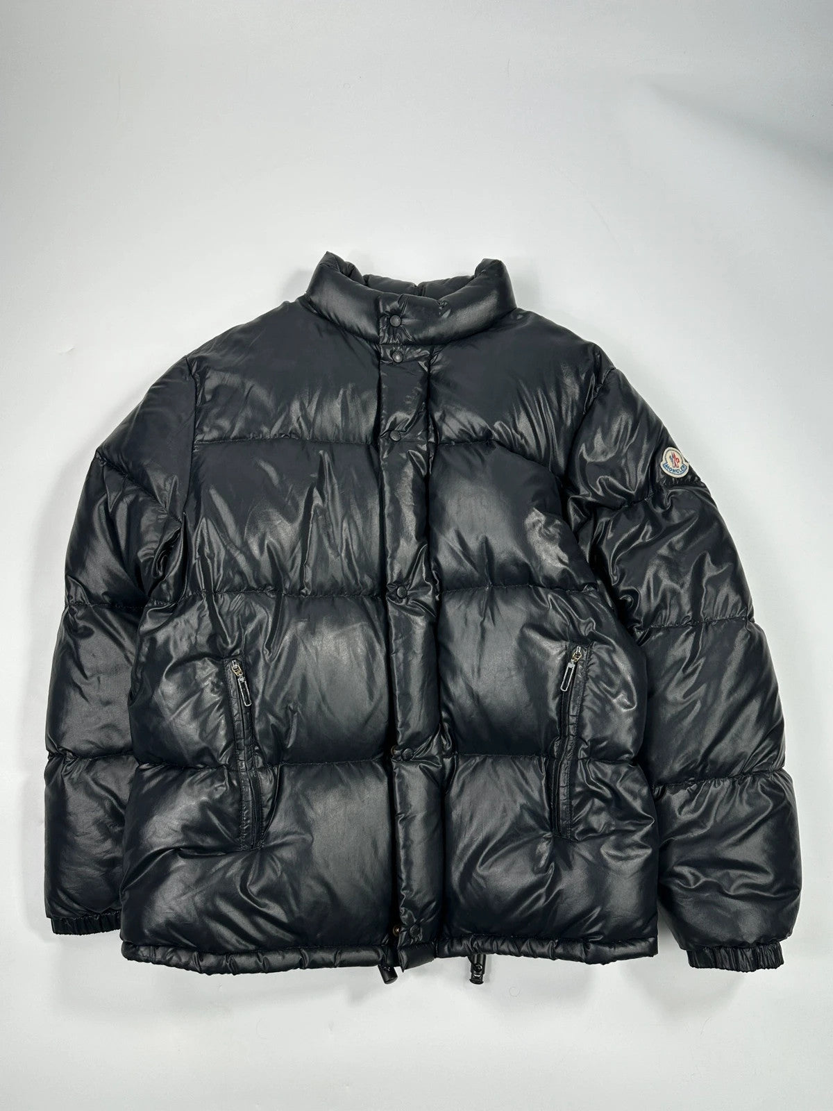 Moncler black nylon hooded puffer jacket with vintage logo and down filling.