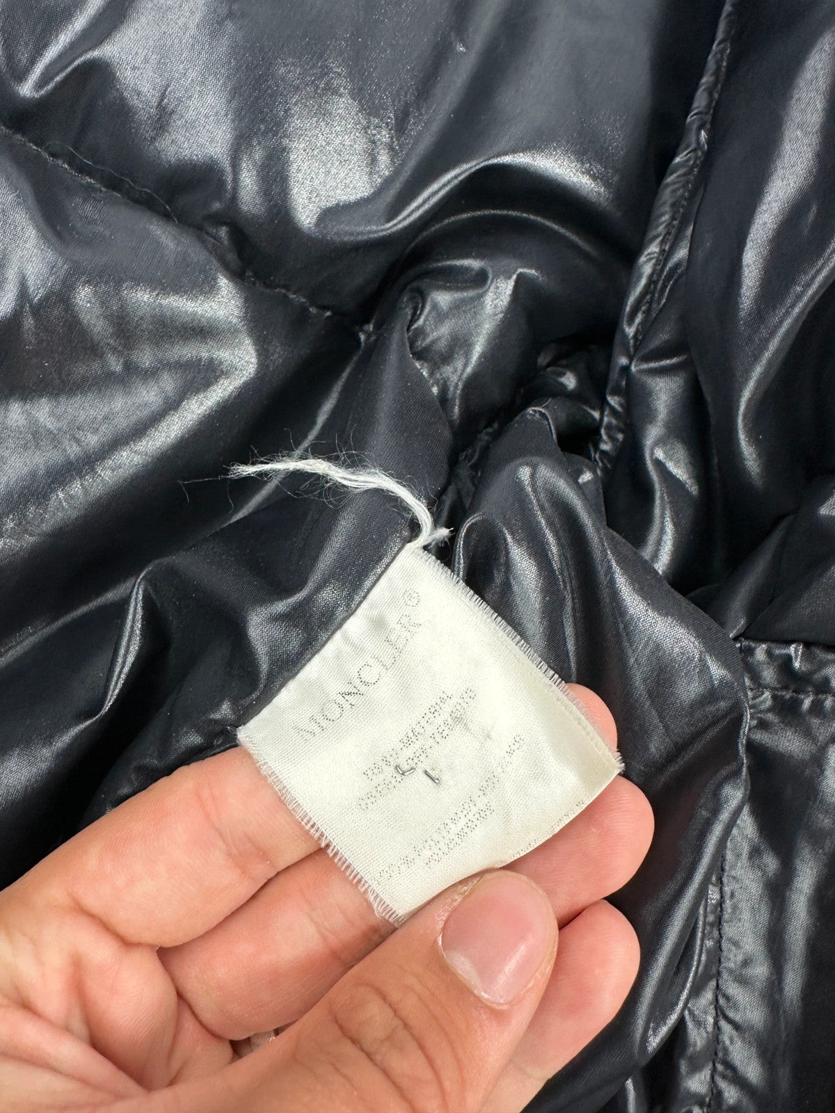 Moncler black nylon hooded puffer jacket with vintage logo and down filling.
